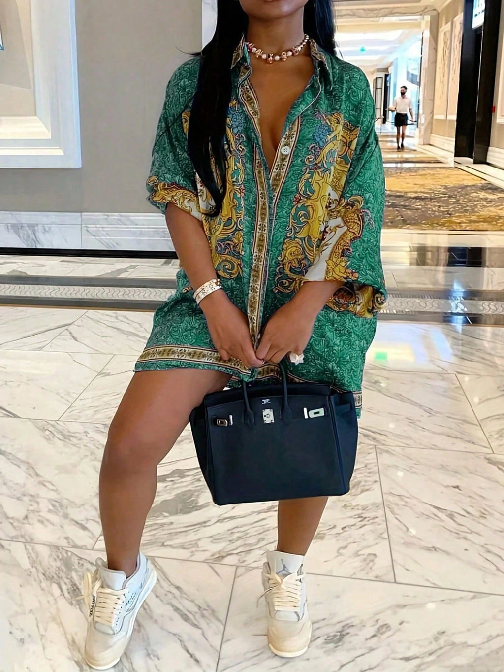 Chemise fluide à manches longues portée de manière oversize.